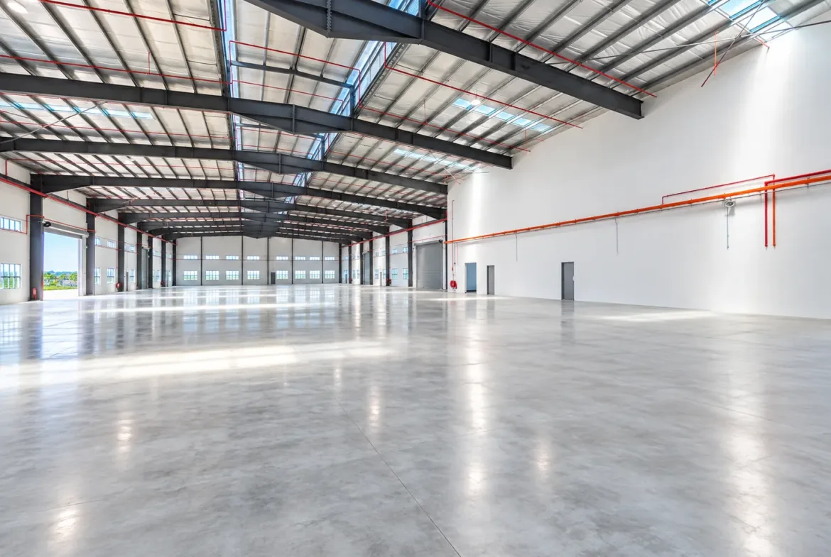 Detached factory for sale in Desa Cemerlang – interior with roller shutter doors